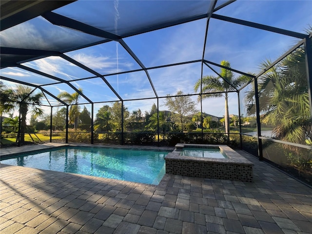 view of pool with an in ground hot tub, a patio area, and a lanai