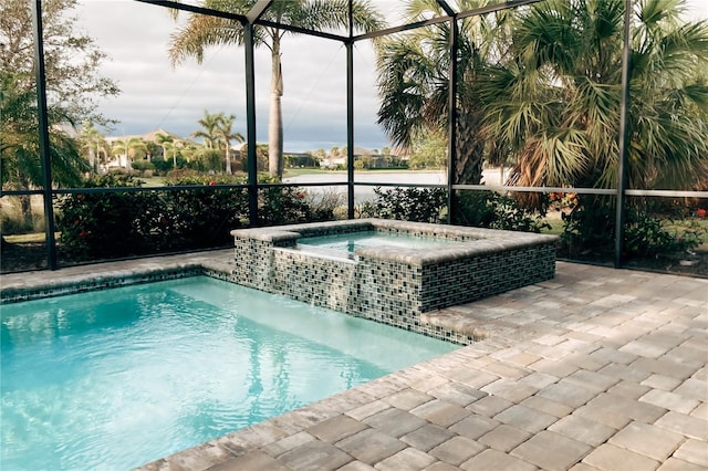 view of swimming pool with an in ground hot tub and a lanai