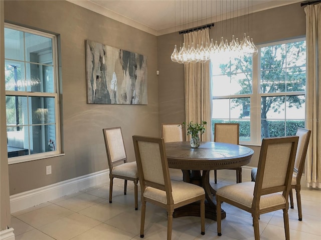 tiled dining space featuring plenty of natural light and crown molding