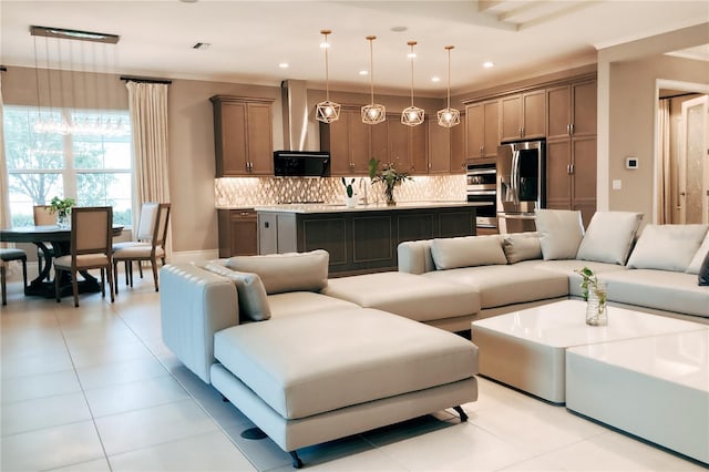 living room with ornamental molding and light tile patterned flooring