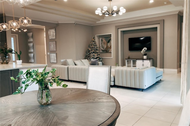 tiled dining space with a tray ceiling, crown molding, and a notable chandelier