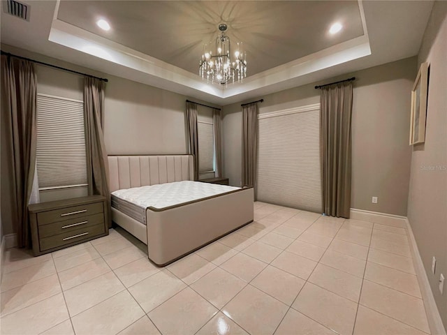 unfurnished bedroom featuring a raised ceiling and light tile patterned floors