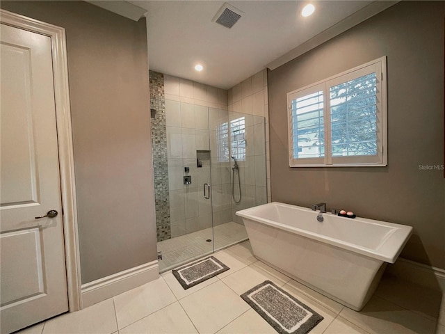 bathroom with tile patterned flooring and separate shower and tub