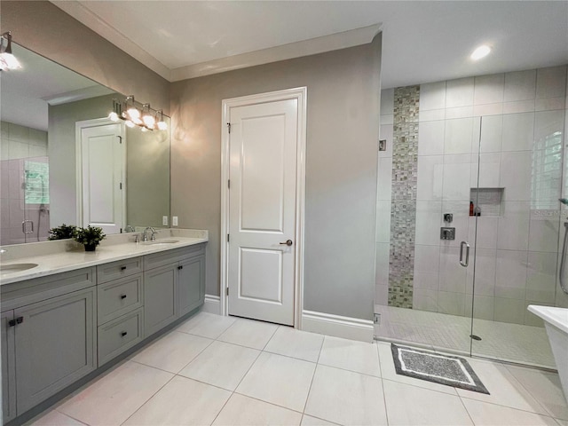 bathroom featuring tile patterned flooring, vanity, and a shower with door