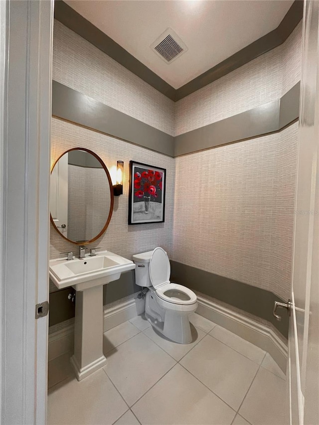 bathroom featuring tile patterned flooring and toilet