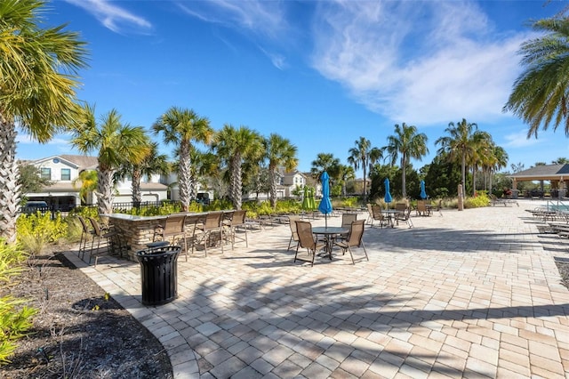 surrounding community featuring a bar and a patio area