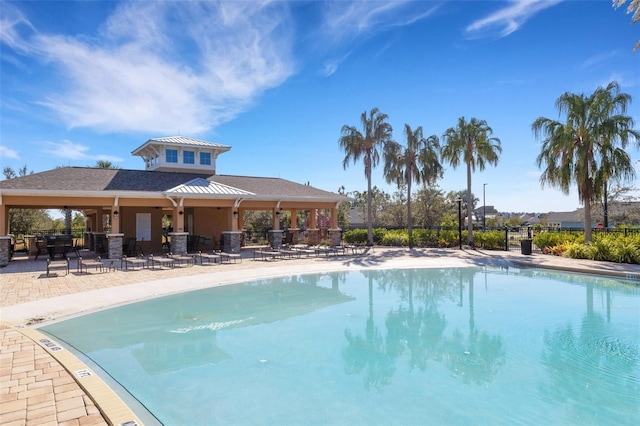 pool featuring a patio area and fence