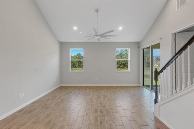 empty room with stairs, light wood-style flooring, visible vents, and baseboards