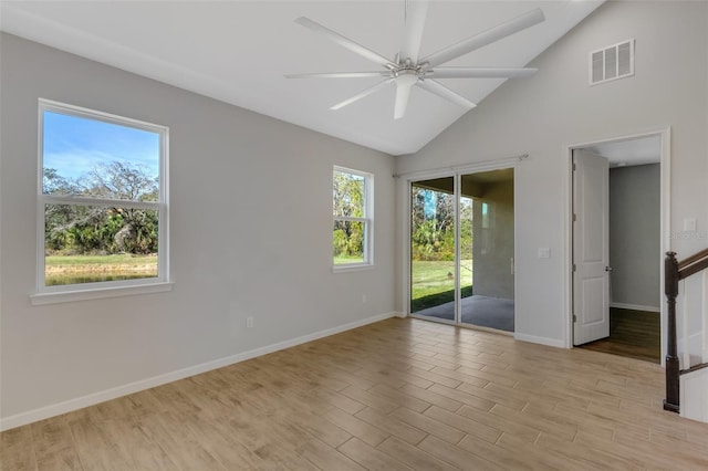 empty room featuring light wood-style floors, baseboards, visible vents, and a ceiling fan