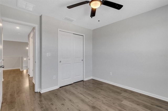 unfurnished bedroom with light wood-style floors, visible vents, and baseboards