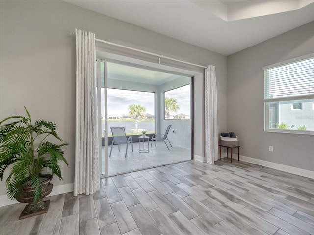 spare room featuring light wood-style flooring and baseboards