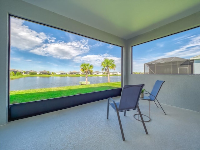 sunroom / solarium featuring a water view