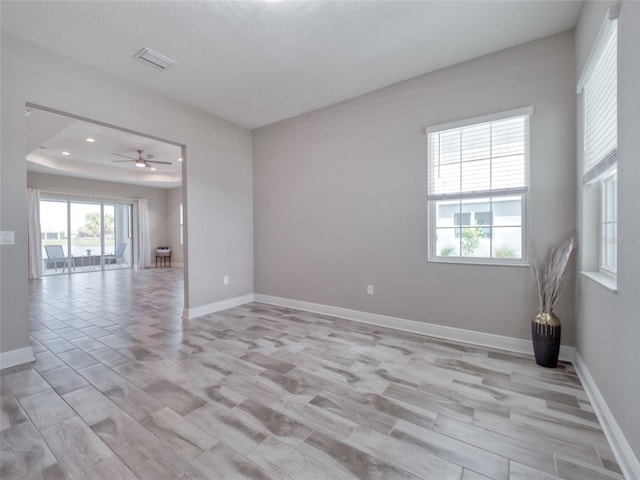 spare room with light wood-style flooring, recessed lighting, visible vents, and baseboards