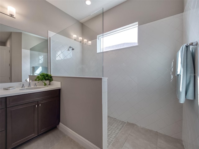 bathroom with tile patterned floors, vanity, and walk in shower