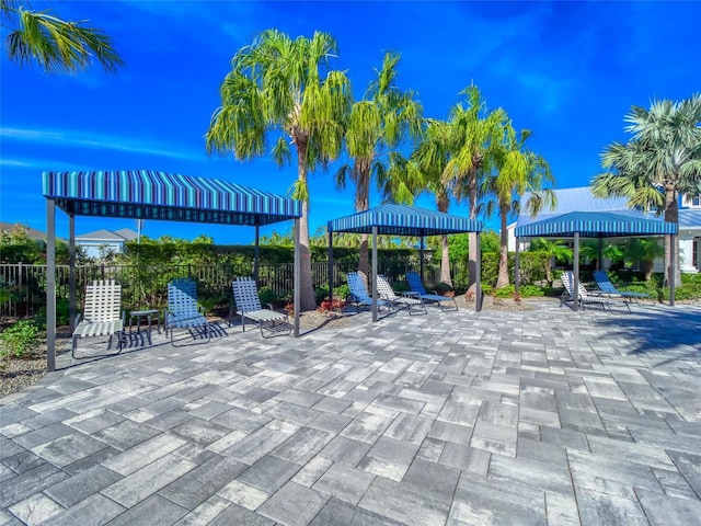 surrounding community with a patio area, fence, and a gazebo