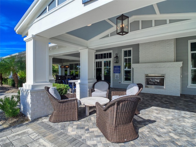 view of patio with an outdoor brick fireplace