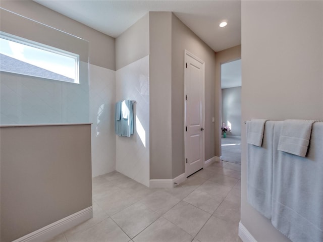 bathroom with baseboards and tile patterned floors