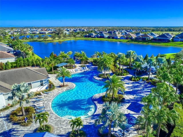 pool featuring a water view, a patio area, and a residential view