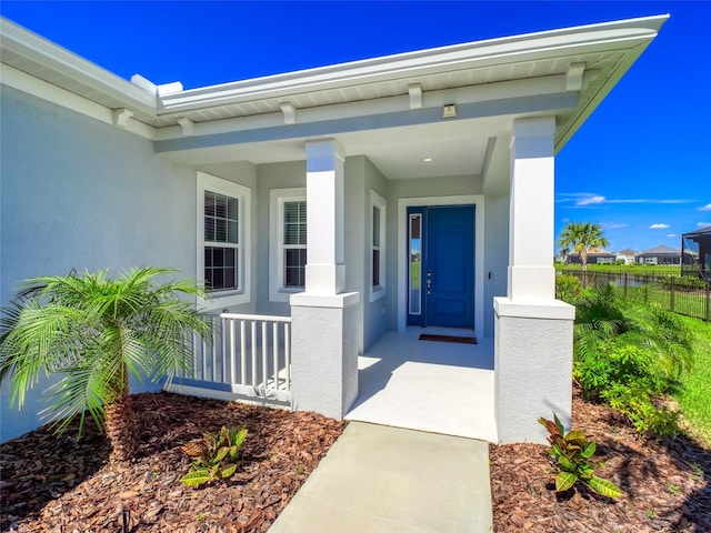 entrance to property featuring stucco siding