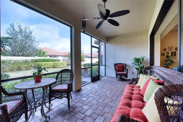 sunroom featuring ceiling fan