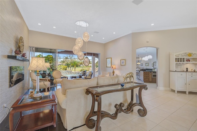 living room with light tile patterned floors and crown molding