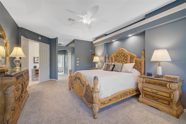 bedroom with carpet, a tray ceiling, and ceiling fan