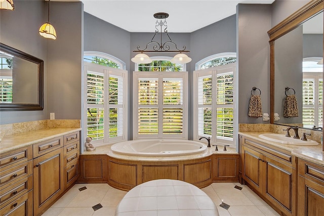 bathroom featuring tile patterned floors, a washtub, and vanity