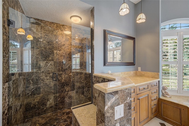 bathroom with tiled shower and a textured ceiling