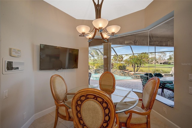 tiled dining room featuring plenty of natural light and an inviting chandelier