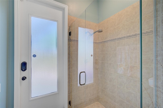 bathroom featuring a shower with door