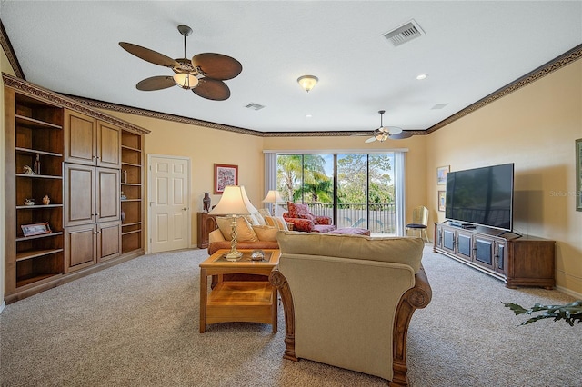 carpeted living room with ceiling fan and ornamental molding