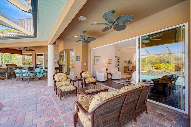 view of patio featuring a grill, a balcony, and an outdoor hangout area