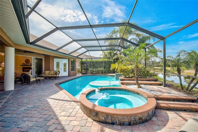 view of pool with glass enclosure, french doors, an in ground hot tub, a water view, and a patio