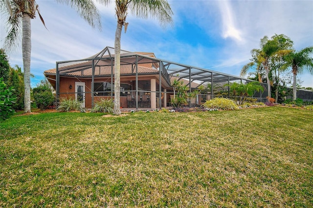 back of property with a lanai and a yard