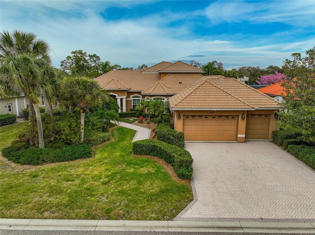 mediterranean / spanish house with a garage and a front yard