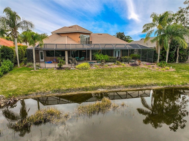 back of house with a patio, a water view, and glass enclosure