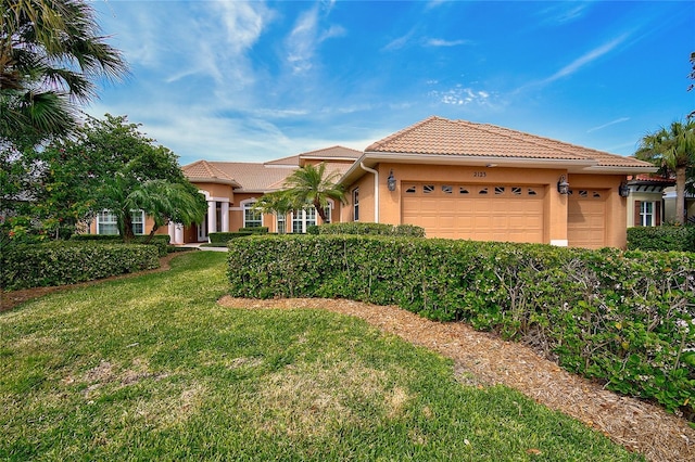 view of front of property with a front yard and a garage