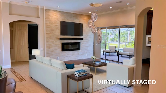 2123 Calusa Lakes Blvd, Nokomis, FL 34275 - living area featuring arched walkways, tile patterned flooring, recessed lighting, a fireplace, and ornamental molding