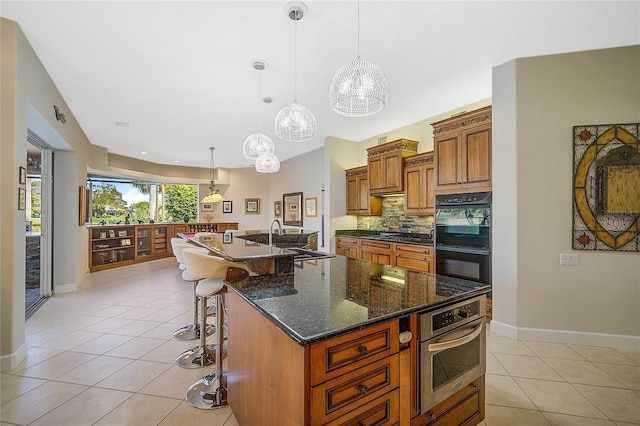 2123 Calusa Lakes Blvd, Nokomis, FL 34275 - kitchen featuring a sink, brown cabinetry, light tile patterned floors, baseboards, and a chandelier