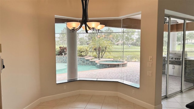 2123 Calusa Lakes Blvd, Nokomis, FL 34275 - unfurnished dining area featuring tile patterned flooring, baseboards, and a chandelier