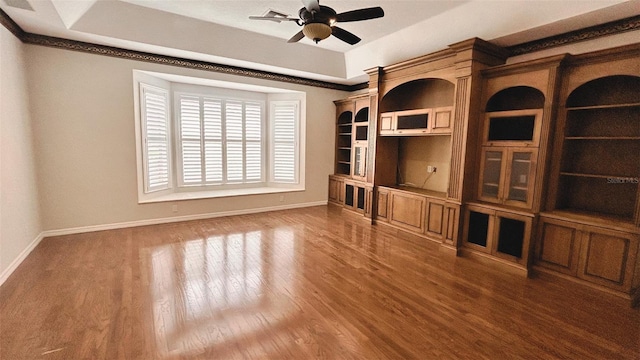 2123 Calusa Lakes Blvd, Nokomis, FL 34275 - unfurnished living room with wood finished floors, baseboards, and a ceiling fan