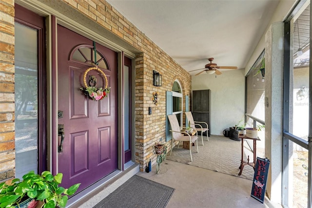 doorway to property with ceiling fan and covered porch