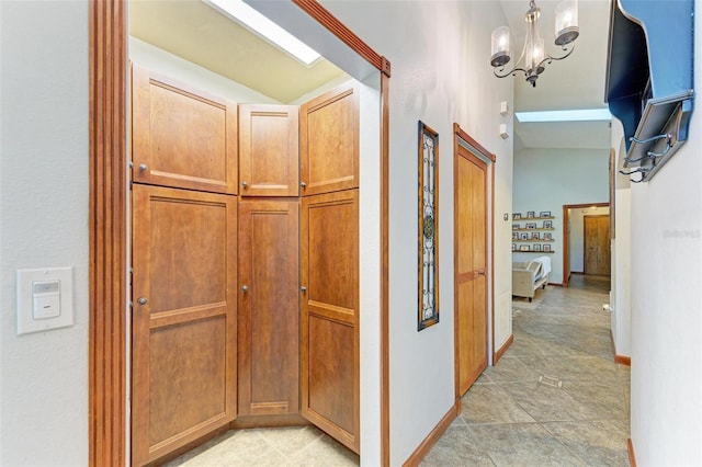 hallway with an inviting chandelier