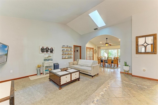 living room featuring vaulted ceiling, ceiling fan, and light tile patterned flooring