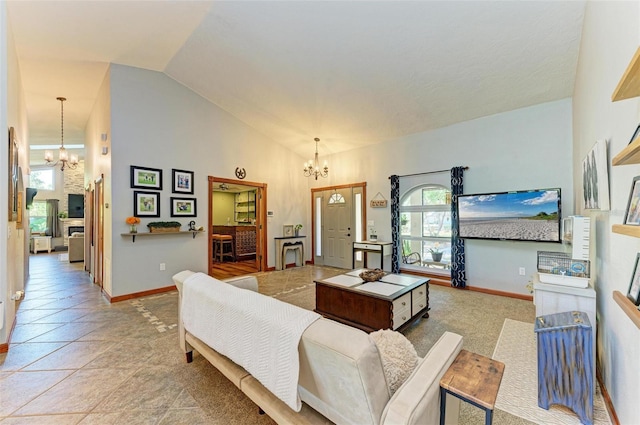 tiled living room featuring high vaulted ceiling and a notable chandelier