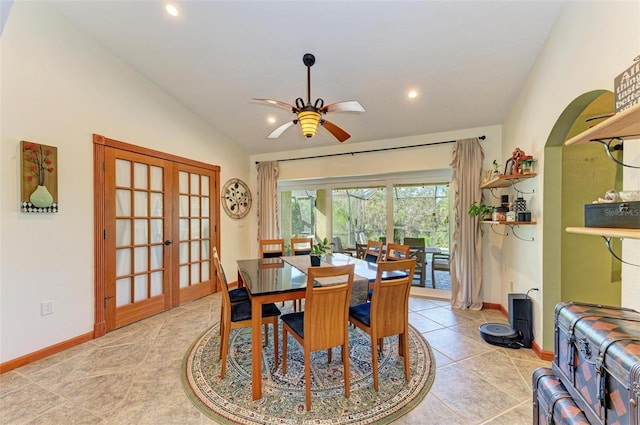 dining area featuring ceiling fan, french doors, light tile patterned floors, and lofted ceiling