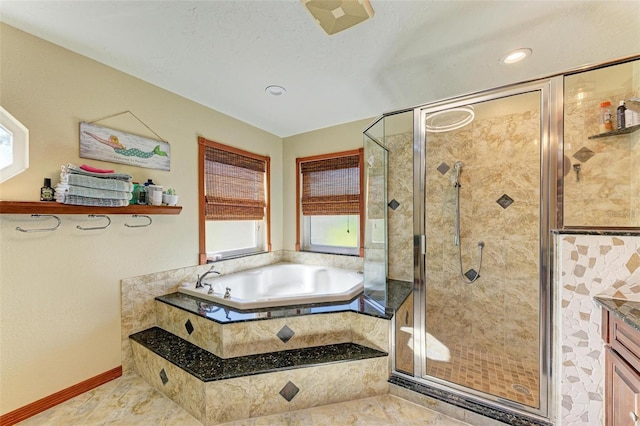 bathroom featuring vanity and independent shower and bath