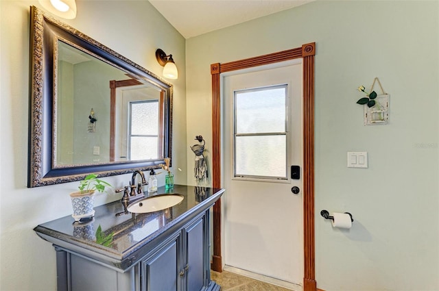 bathroom with tile patterned floors, plenty of natural light, and vanity