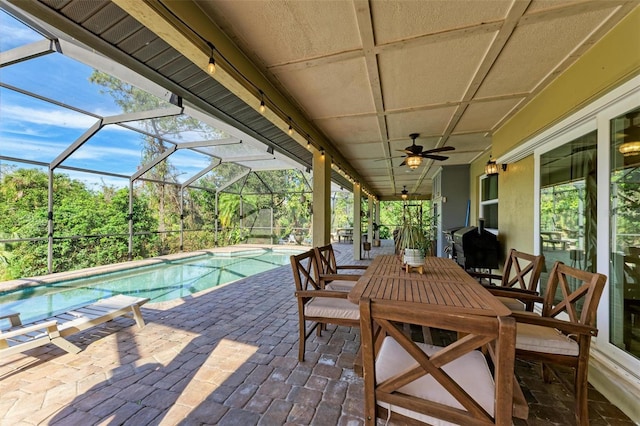 view of swimming pool featuring a lanai, ceiling fan, and a patio