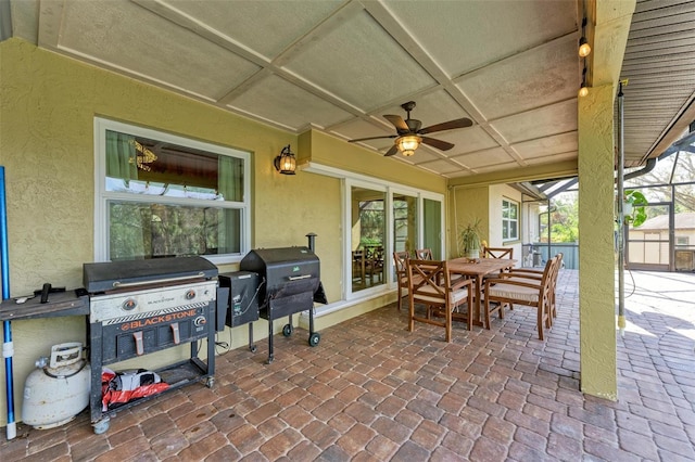 view of patio featuring grilling area, a lanai, and ceiling fan